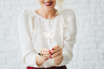 Happy Woman Holding Sparklers