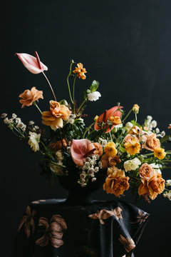 Florist in studio building a stunning floral arrangement