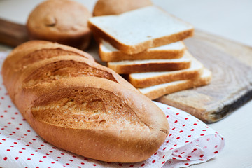 fresh white loaf of bread, toasts and cupcakes - 268195212