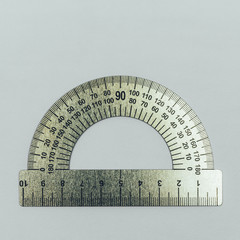 metal protractor close-up on grey background top view