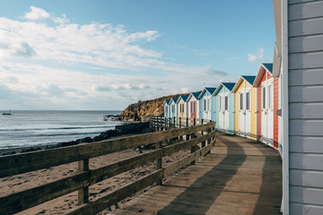 Colourful beach huts on the seafront. Bude, Cornwall, UK.