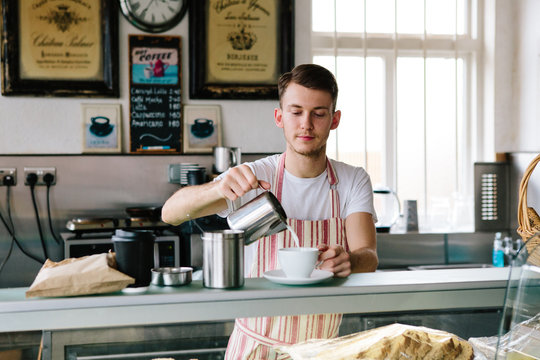Young man making coffee in a small bakery business
