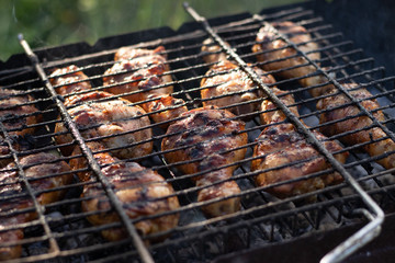 Fragrant chicken legs in the grill.