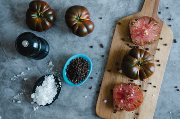 Sweet Marmande tomatoes on stone background. Flat lay.