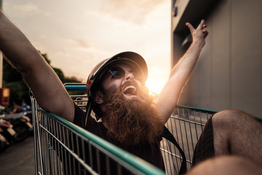Funny bearded hipster enjoying in the street.