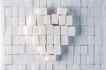 light sweet background: heart on a plane of refined sugar