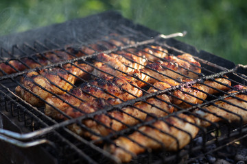 Fragrant chicken legs in the grill.