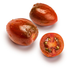 Close-up of cherry tomatoes (mini kumakos) cut in half and whole. With drops of water. Isolated on white background.