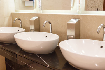 Naklejka na ściany i meble White sinks with taps