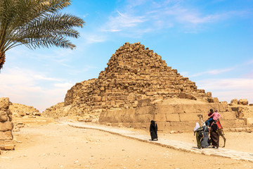 Arabian tourists near one of the Pyramids of Giza, Egypt