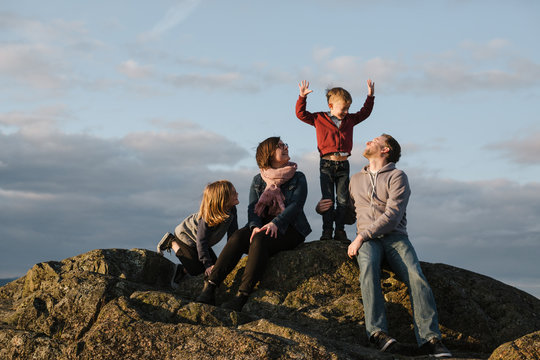 Fun family of four spending time together in nature