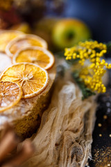 Biscuit apple pie with cinnamon, citron, oriental spices and sugar powder on dark background