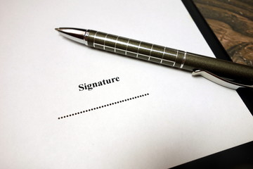 Blank space for signature on document with pen