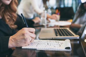 Office: Woman Brainstorms On Notepad During Meeting