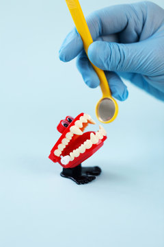 Dentist visits dracula chattering teeth with inspection mirror