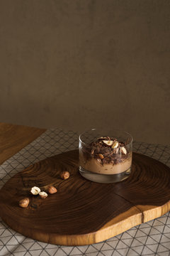 Chocolate cream in a cup with hazelnuts