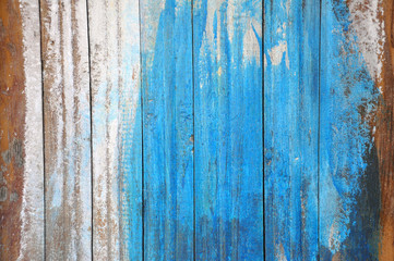 Fototapeta na wymiar Old white wall of planks painted blue.