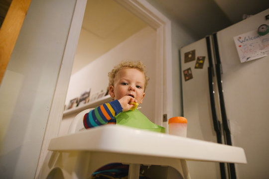 Messy toddler eating breakfast