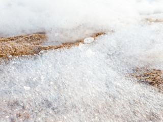 Closeup abstract image of soap foam lying on sandy sea beach after beach disco party