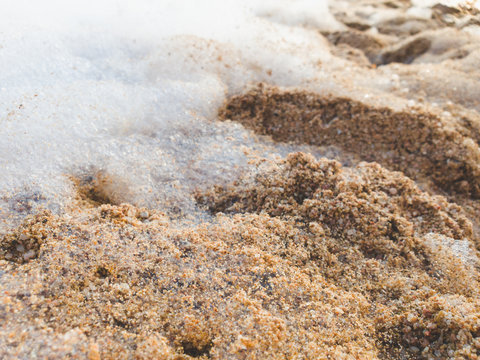 Closeup image of foam and suds on the sand at sea beach. Abstract background. © Кирилл Рыжов