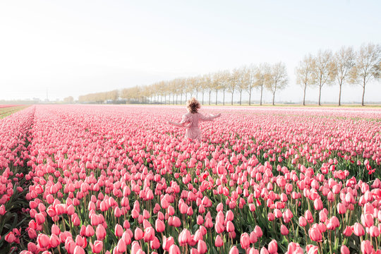 Happy young woman in a tulip field