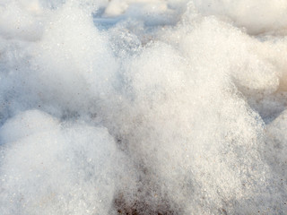 Fototapeta na wymiar Closeup macro abstract image of soap foam in bright sunny days. Closeup photo of clouds