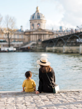 Mom and baby sitting at Seine River