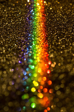 Golden glitter with a prism of light