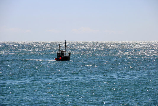 Fishing Boat in the Open Sea in Early Evening