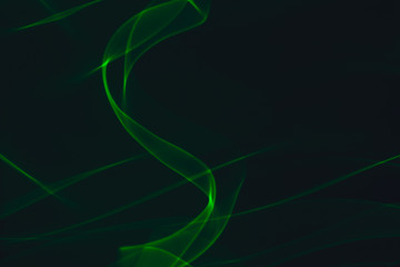 Green neon lines. Abstract black background. Neon lights texture.