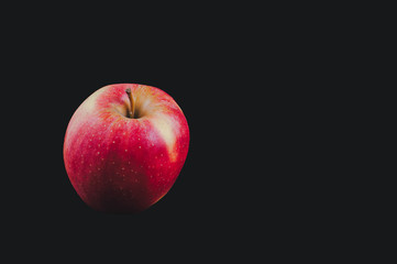 Fototapeta na wymiar Apple fruits on a black background ordinary