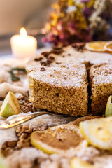 Biscuit apple pie with cinnamon, citron, oriental spices and sugar powder on dark background