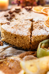 Biscuit apple pie with cinnamon, citron, oriental spices and sugar powder on dark background