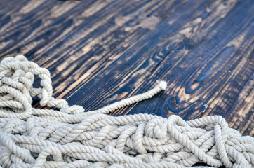 Ship rope on rustic wooden background.  Copy space.