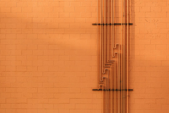 Orange Wall with Network Pipes