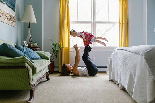 Child Balancing on her Mother's Feet