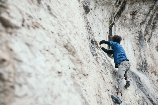 Man climbing upright rock