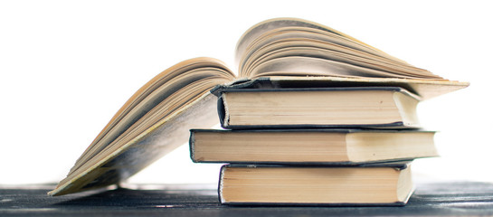 Heap pile of rare books. Open book, hardback books on wooden table. Education background. Back to school. Copy space for text. Bestseller, business. Stack books and red bookmark