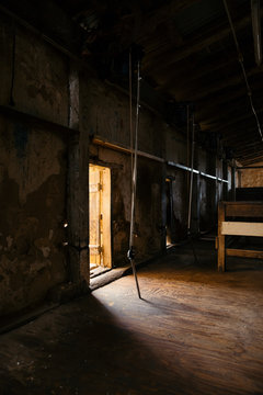 Old fashioned shaft driven overhead shearing gear inside an old vintage shearing shed