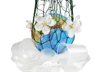 Planet the earth in a grid, flowers of an apple-tree and plastic garbage. Pollution by plastic debris. Isolated white background.