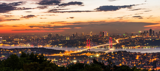 Istanbul Bosphorus Bridge at sunset. 15th July Martyrs Bridge. Night view from Camlica Hill. Istanbul, Turkey..