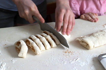 Children mold cheesecakes from dough. Kitchen table in flour. Warm relationships children