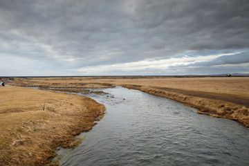 The Seljalands River flows into the distant horizon