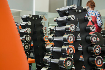 Sports dumbbells in modern sports club. Weight Training Equipment