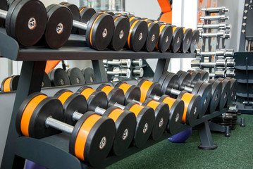 Fototapeta na wymiar Sports dumbbells in modern sports club. Weight Training Equipment