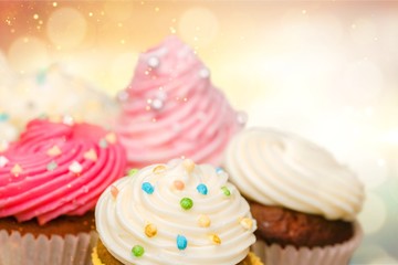 Tasty Colorful cupcakes on background