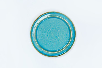 Simple rustic handmade blue crockery  on a white background