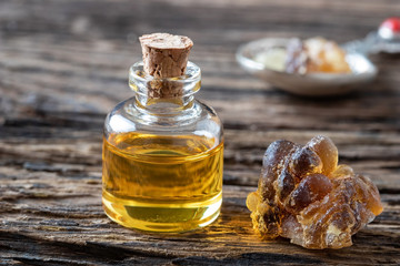 A bottle of frankincense essential oil with frankincense resin