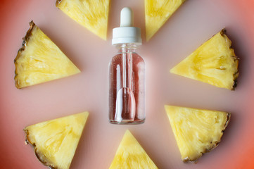Pineapple flavored vape liquid lies with pineapple pieces on a plate