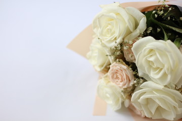 Obraz na płótnie Canvas wedding bouquet of light pastel roses on a white background with a place for an inscription